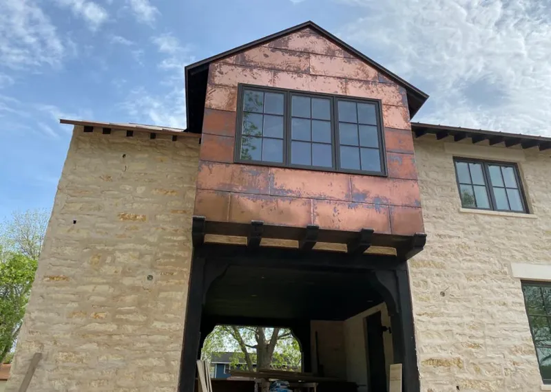 Copper metal panel facade on a stone building for Skylight Installation in Woodridge